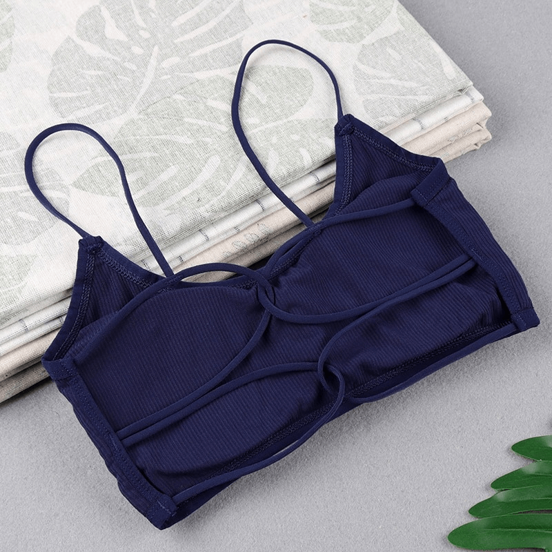 Stylish wireless navy sports bra with open back design on fabric, ideal for yoga. Breathable modal material. SF0505.
